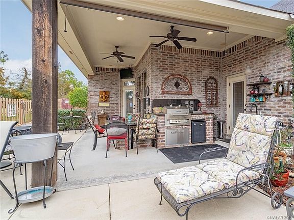 Relaxing outdoor entertainment area complete with a kitchen and granite table