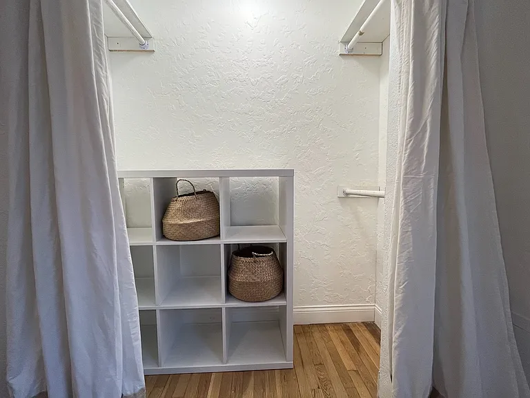 Closets furnished with cube storage and clothes hanging bars