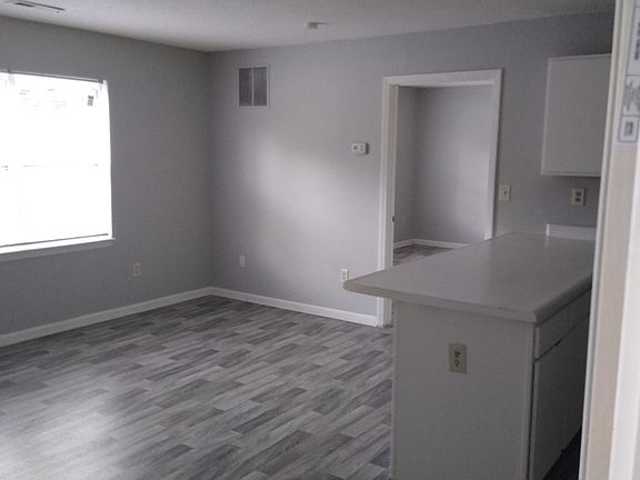 Renovated Living space with grey wood-inspired flooring