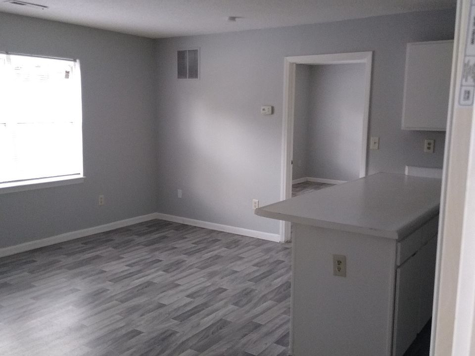 Renovated Living space with grey wood-inspired flooring