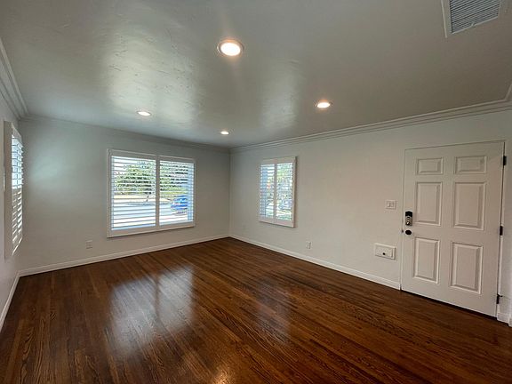 Large living room with recessed lights, new dual paned windows