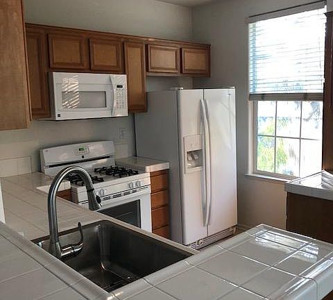 Kitchen with new sink, range, and microwave