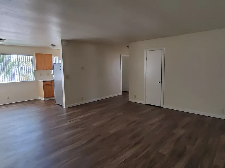 View from front door of living room, dining room and kitchen at Zenith Place Apartments in Chula Vista, California.