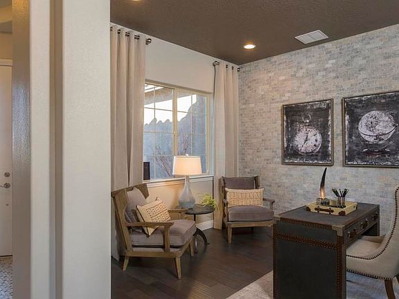 Den at entry of home with decorative tile wall with window opening to courtyard