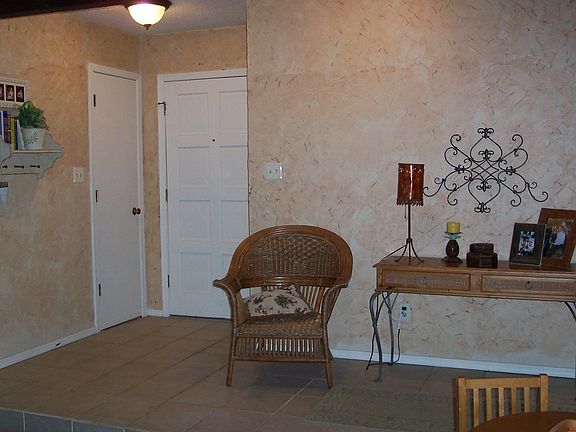 Tiled entry with old world plaster wal;s