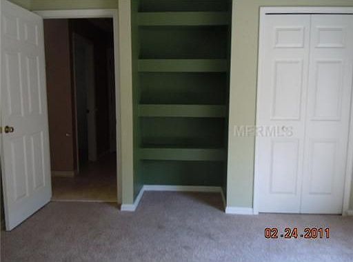 Downstairs bedroom with built in shelving.
