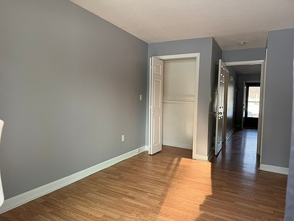Sunny bedroom with attached bathroom, closet, and direct access to the patio.