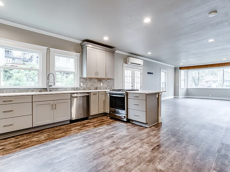 The expansive kitchen enjoys abundant cabinetry and quartz counters.