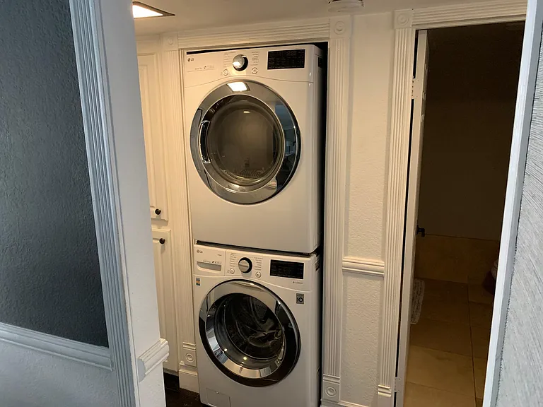 Laundry area. Has slatted, wood foldable door that closes to hide units (for smaller w/d)