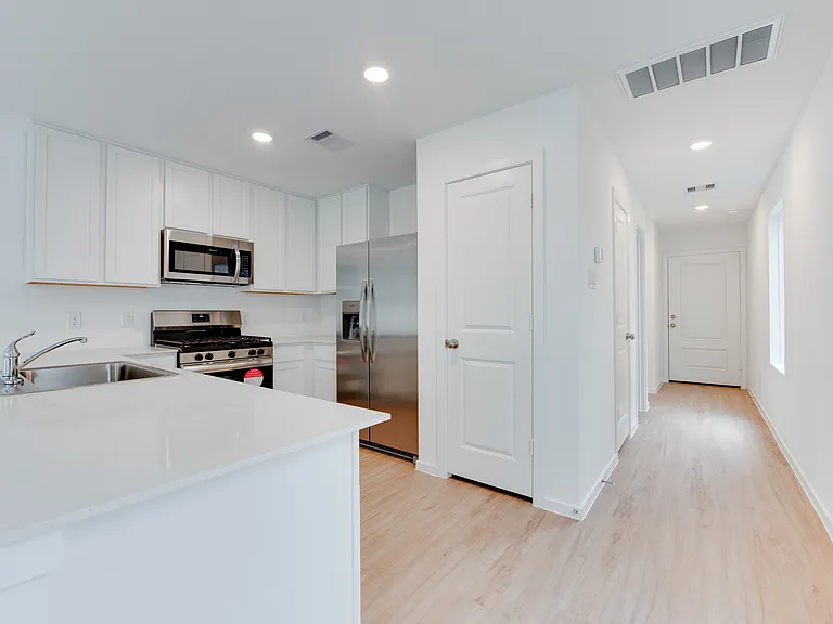 Open kitchen with stainless steel appliances and lots of counter space and storage