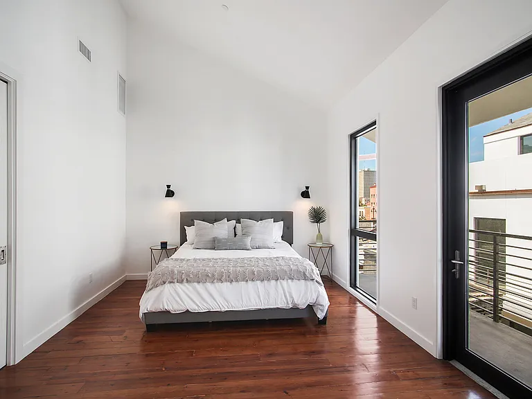 The master bedroom on the third floor has a king bed and a terrace with views of the courtyard and French Quarter.