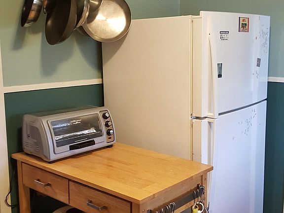 Rolling cart adds counterspace to galley kitchen.