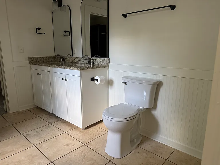 Upstairs bathroom, brand new fixtures, mirrors + toilet.