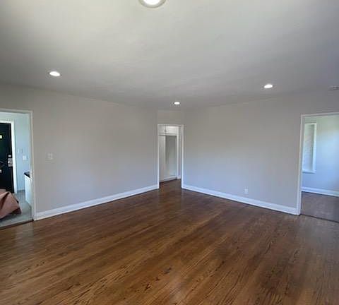 Livingroom with view to front door, hallway & kitchen