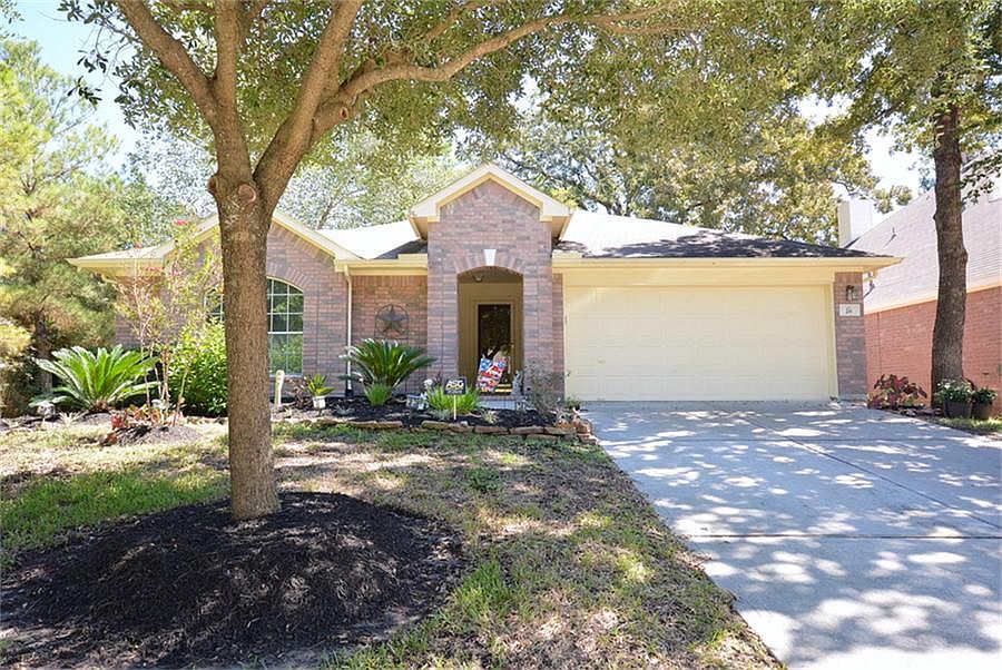 Beautifully landscaped yard with mature shade trees.