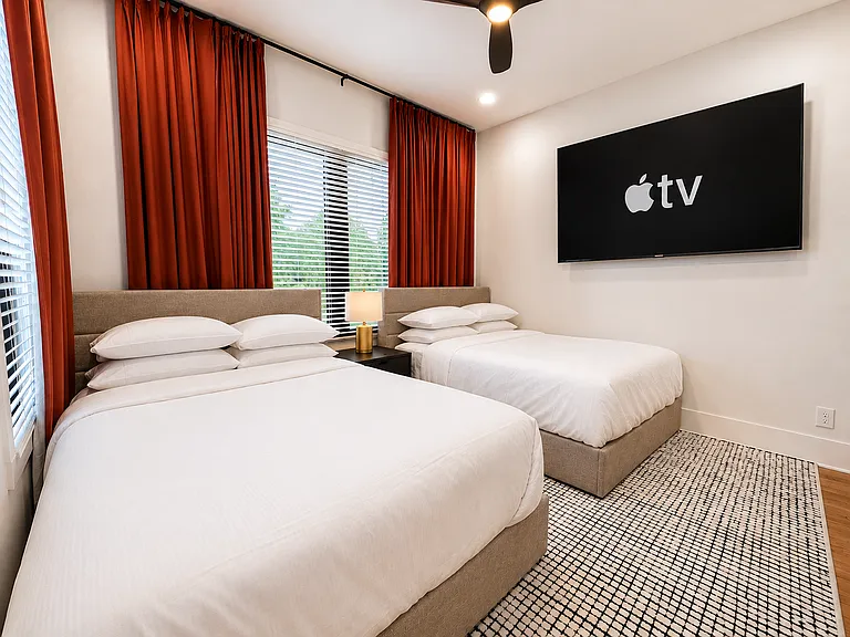 Welcome to the Kirkwood Suite. This double queen retreat with plush bedding, Smart TV, blackout curtains, and lounge-worthy comfort is designed for restful sleep, peaceful mornings, and cozy late-night streaming after a day exploring Atlanta.