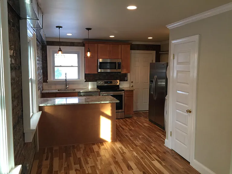 Kitchen. Powder on right. Washer dryer next to fridge.