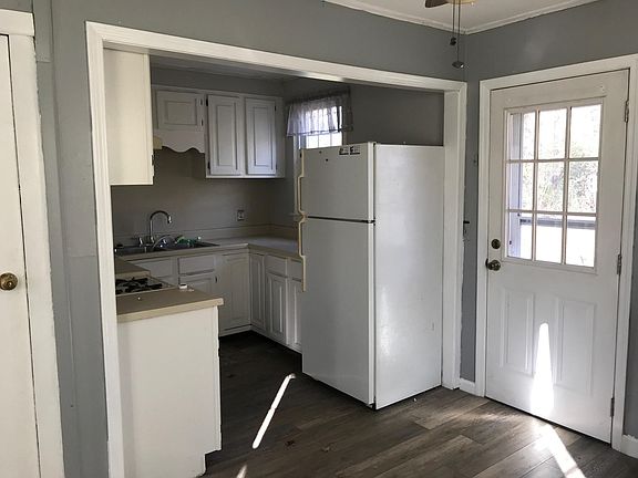 Kitchen area with door to fenced in back yard.
