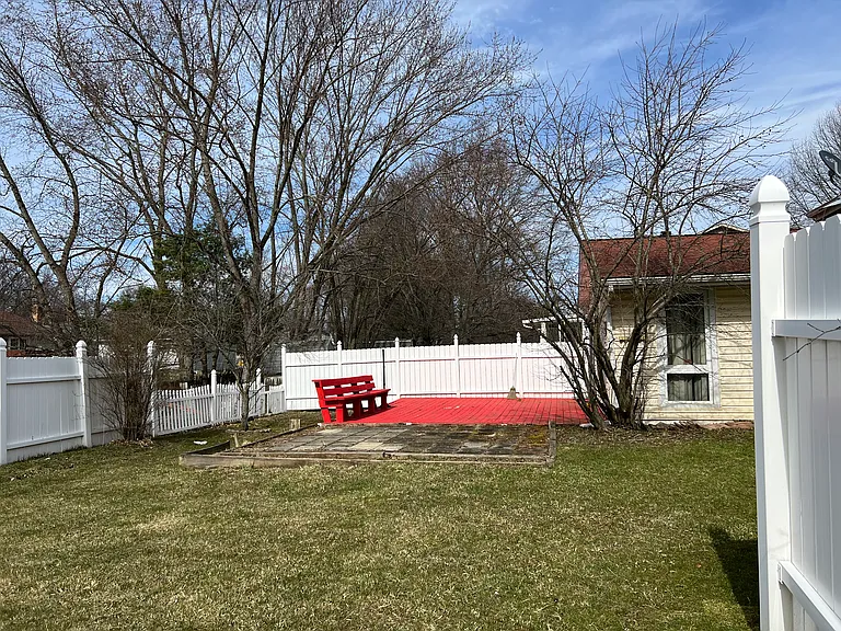 fenced-in flat backyard w/deck