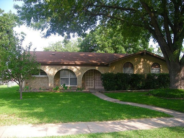 Mature landscaping with  large trees.