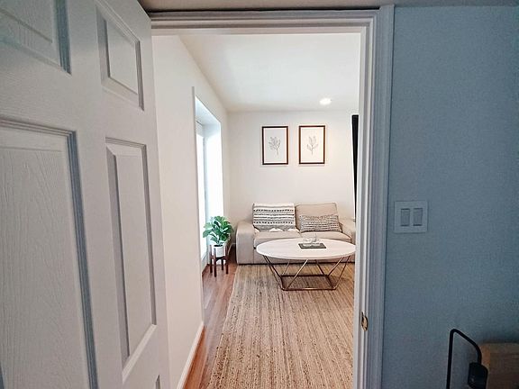 View of the living room through the doors from the bedroom.