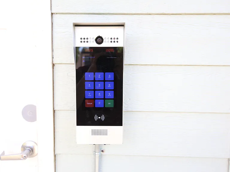 Modern access control keypad with a sleek design, offering secure entry in a stylish building.