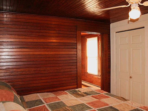 Master bedroom  Much of the original wainscoting has been preserved.