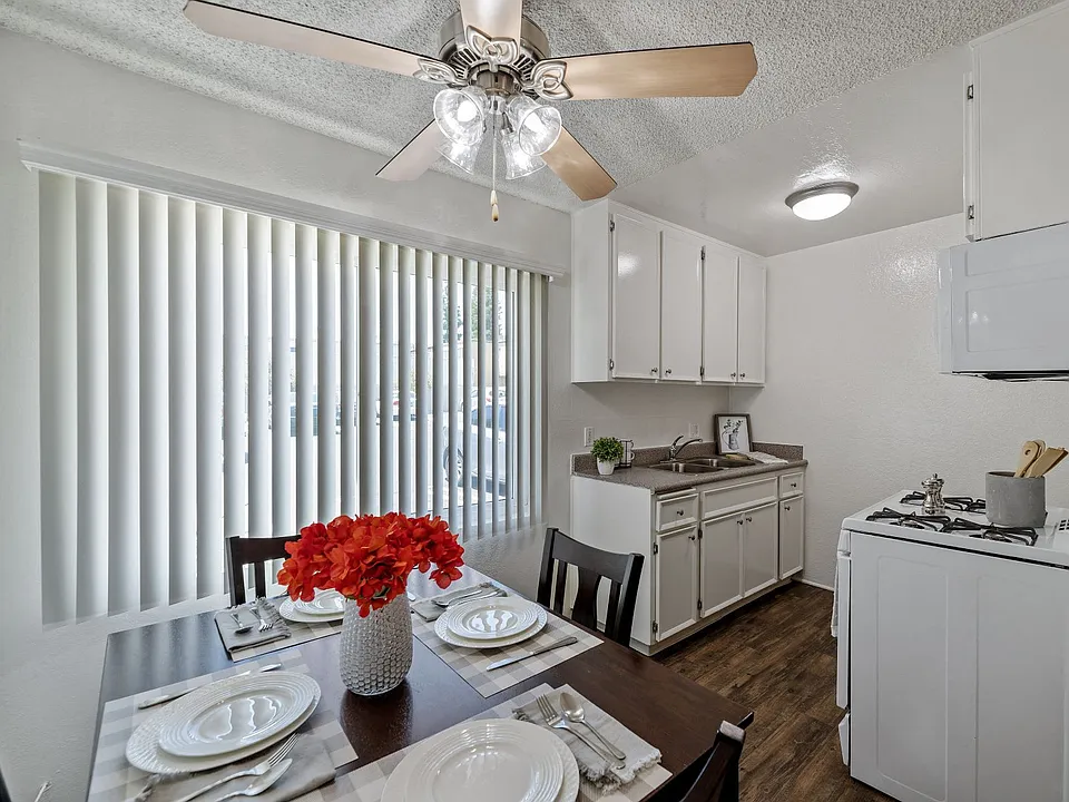 Open concept dining and kitchen with plank flooring in a one bedroom townhome apartment at the Arbor in Studio City, CA