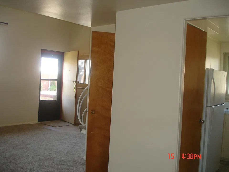 front door, living room, closet under the stairs and kitchen