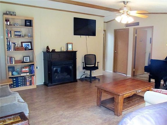 Another view of living room with fireplace and new flooring.