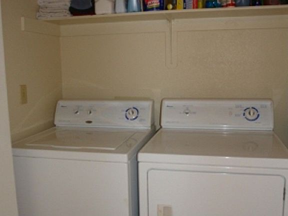 Seperate laundry area with shelf storage