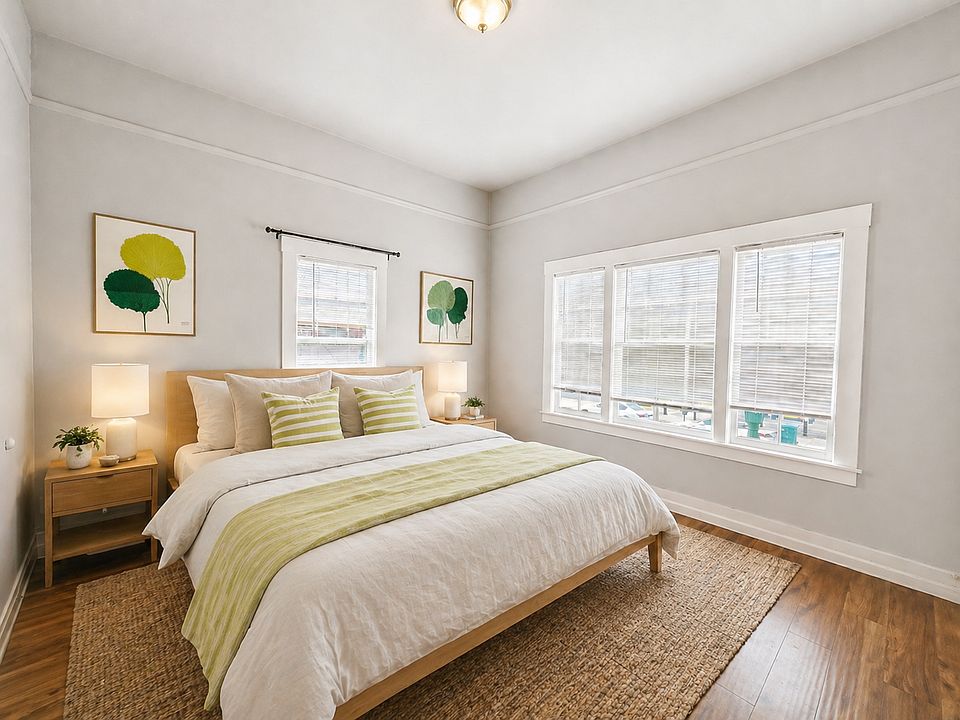 Bedroom 1 
Spacious, sunlit bedroom with warm hardwood floors and calming designer touches_plenty of room for a full setup.