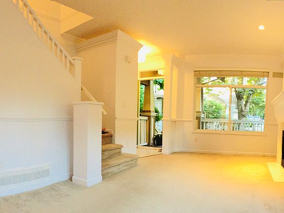 Entrance with small foyer, covered deck outside - enter into living room/dining room