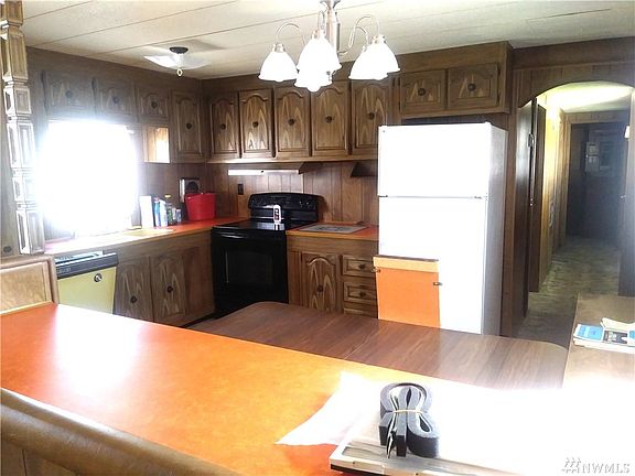Kitchen standing from living room. Dining table stays with house.