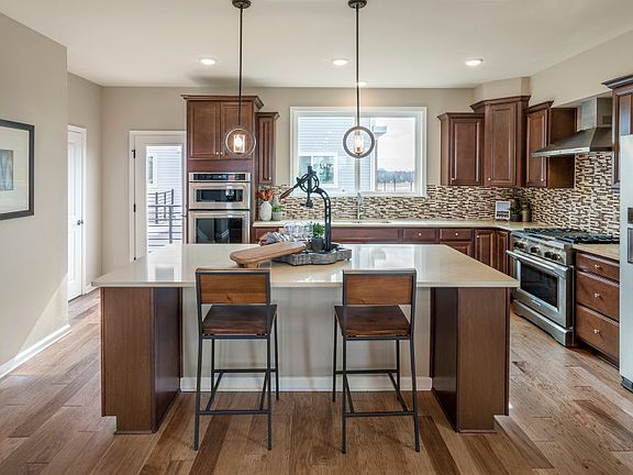 additional seating at the large center island in the state of the art designed kitchen