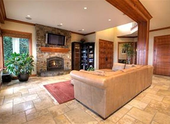 Great Room with tumbled Travertine floor, gas fireplace and French doors to large deck.