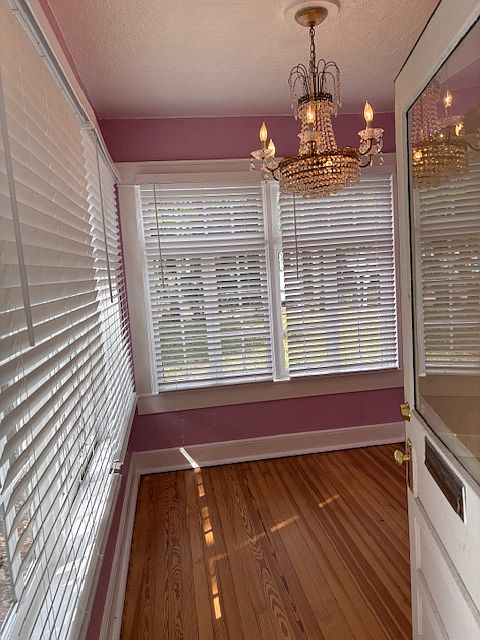 Entrance to Florida Room, crystal chandelier, hardwood floors, new fixtures and blinds, possible home home office