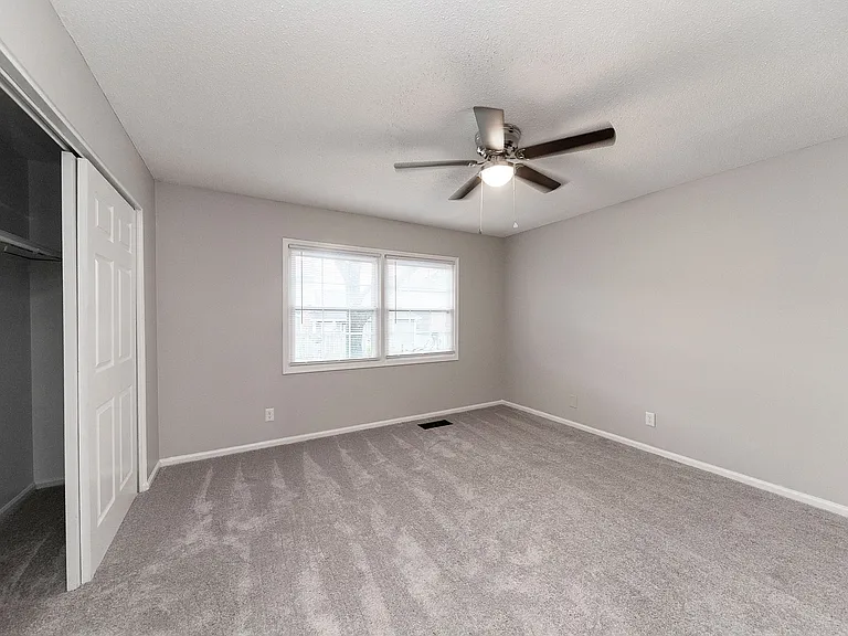 Cozy bedroom with carpet & ceiling fan