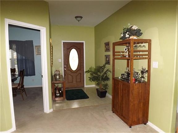 Entry way features tile floors and leaded glass front door. Room to left can be study, dining room or a 4th BR.