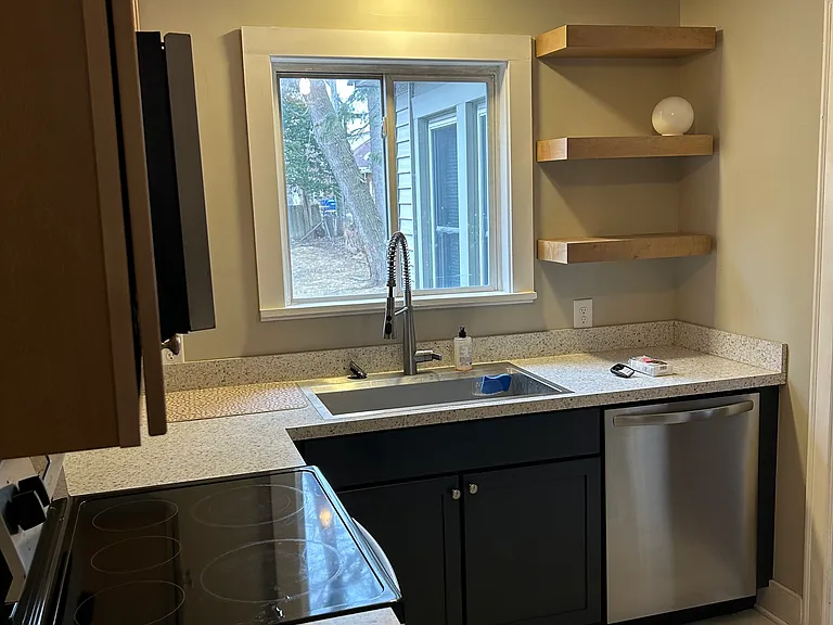 Updated kitchen with dishwasher, stove, microwave, and refrigerator