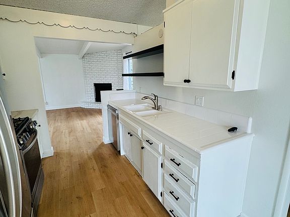 Shelving in kitchen with new dishwasher
