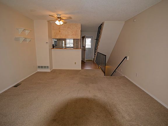 Living area facing kitchen and entry