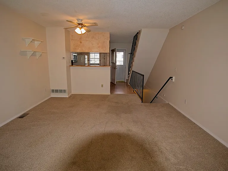 Living area facing kitchen and entry