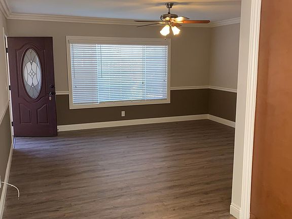 View of the living area as seen from the dining area, with front door on the left