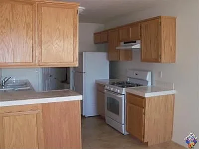Tile counters and floors in kitchen. Newer appliances