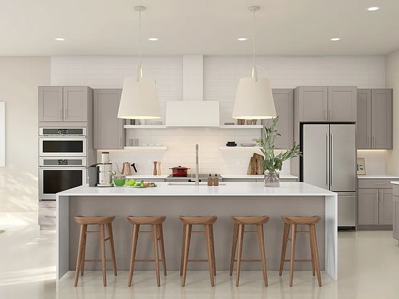 Kitchen featuring vast island pendant lights