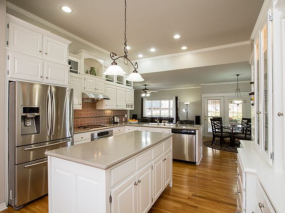 Gorgeous white & stainless Kitchen with custom cabinetry, center island, large breakfast bar and walk-in pantry. 
