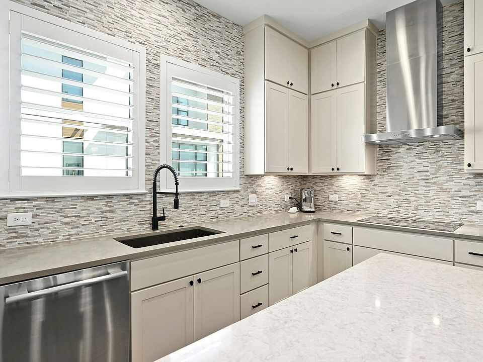 Gourmet kitchen, clean lines, under cabinet lighting, full backsplash, elegant lighting, abundant storage.