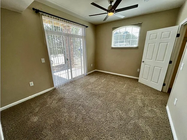 Second bedroom with sliding glass door leading to second porch area.