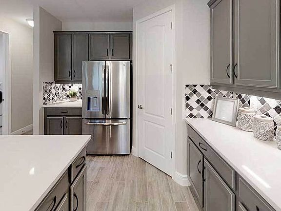 Sandalwood model home kitchen detail with laundry room beyond William Ryan Homes Tampa